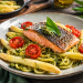 Fotorealistisches Gericht mit knusprig gebratener Lachsforelle auf Bärlauchspaghetti, dazu weißer Spargel und halbierte, leicht geröstete Cherrytomaten auf einem rustikalen Teller.